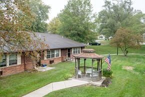 Mechanicsburg apartment for rent - a house with a gazebo in the yard and a flag