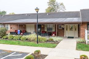 Mechanicsburg apartment for rent - the front of a brick building with a porch and a lawn