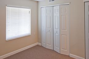 Rushville apartment for rent - a bedroom with two closets and a window with blinds