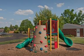Rushville apartment for rent - a playground with two slides and a large rock climbing wall
