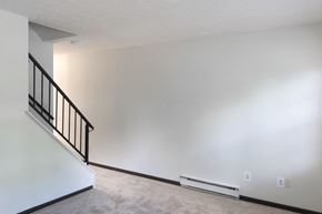 Kenton apartment for rent - an empty living room with white walls and a staircase