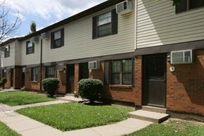 Kenton apartment for rent - a brick and white building with a sidewalk and grass