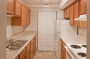 Greensburg apartment for rent - a kitchen with wooden cabinets and a white refrigerator
