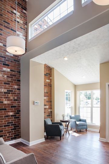 Delaware apartment for rent - a living room with a brick wall and chairs and a table