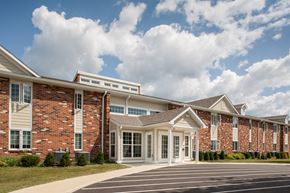 Delaware apartment for rent - an exterior view of a brick building with white columns and windows