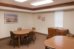 Rockville apartment for rent - a conference room with a table and chairs and a dresser