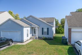 Columbus apartment for rent - a blue house with a yard and a garage