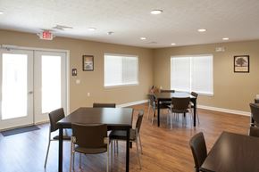 South Point apartment for rent - a dining room with tables and chairs and a door