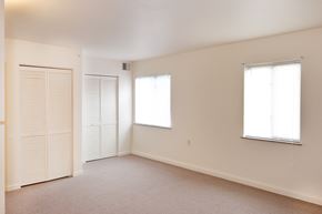 Cincinnati apartment for rent - an empty living room with white walls and a door and window