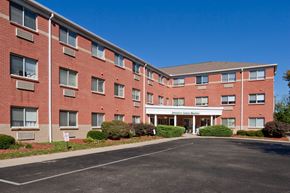 Cincinnati apartment for rent - a large brick building with a driveway in front of it