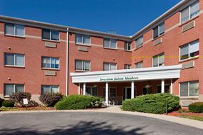 Cincinnati apartment for rent - an exterior view of a brick building with a white entrance