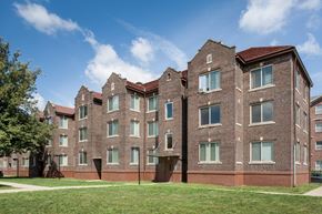 Indianapolis apartment for rent - a large brick building with grass in front of it