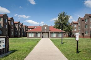 Indianapolis apartment for rent - a pathway leading to a building with a sidewalk and grass