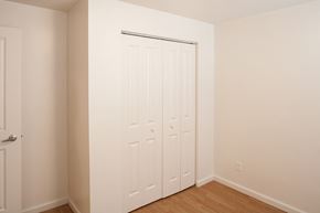 Indianapolis apartment for rent - a bedroom with two closets and a wood floor