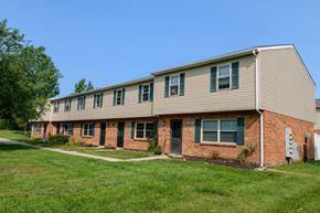Batavia apartment for rent - an apartment building with brick and tan siding and green grass