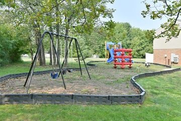 Batavia apartment for rent - a playground with a swing set in a park