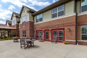 Whitehall apartment for rent - a patio outside of a brick building with tables and chairs