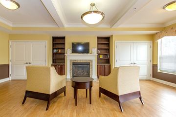 Whitehall apartment for rent - a living room with two chairs and a fireplace