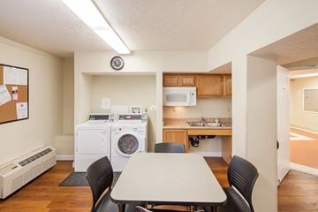 Xenia apartment for rent - a kitchen and dining room with a table and chairs and a washing machine