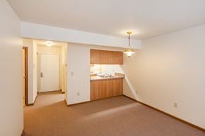 Xenia apartment for rent - a living room with a kitchen and a door to a hallway