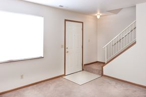 Decatur apartment for rent - an empty living room with a white door and a stairwell