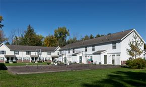 Decatur apartment for rent - a group of white houses with a playground in the yard