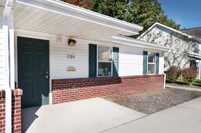 Decatur apartment for rent - the front entrance of a white house with a blue door