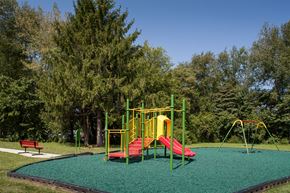 Bedford apartment for rent - a playground with a red and yellow swing set