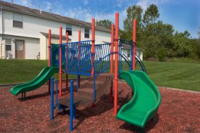 Cambridge apartment for rent - a playground with a slide and a staircase in front of a building