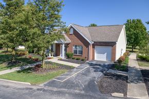 Columbus apartment for rent - a red brick house with a white garage and trees