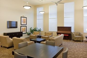 Cambridge apartment for rent - a living room with a table and chairs and a piano