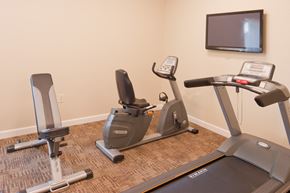 Cambridge apartment for rent - a gym with two exercise bikes and a tv