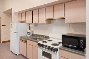 Logansport apartment for rent - a kitchen with a stove microwave and refrigerator