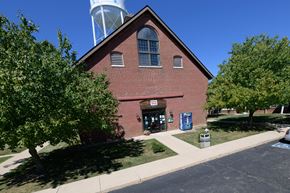 Logansport apartment for rent - an old brick church with a water tower behind it