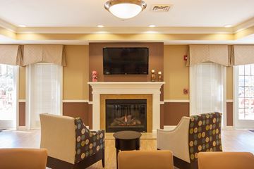 Whitehall apartment for rent - a living room with a fireplace and chairs