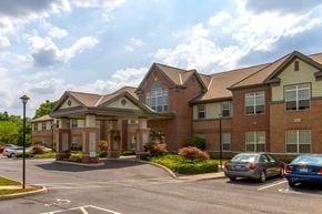 Whitehall apartment for rent - a large brick building with cars parked in front of it