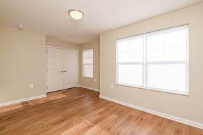 Columbus apartment for rent - an empty living room with wood floors and a white door