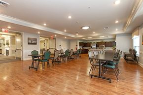 Whitehall apartment for rent - a community room with tables and chairs and a kitchen