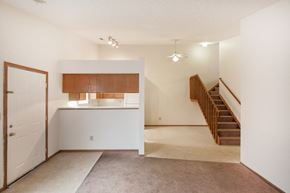 Columbus apartment for rent - an empty living room with a kitchen and stairs in a house
