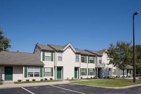 Delaware apartment for rent - a row of houses with green doors and white siding