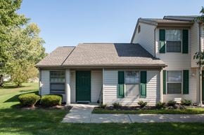 Delaware apartment for rent - a white house with green shutters and a sidewalk
