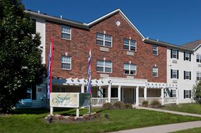 Toledo apartment for rent - the front of a brick building with a sign in front of it