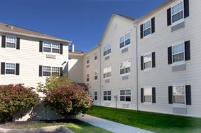 Toledo apartment for rent - an exterior view of an apartment building with a sidewalk and grass