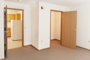 Toledo apartment for rent - a bedroom with a door to a bathroom and a refrigerator