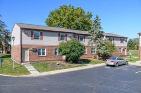 Columbus apartment for rent - an apartment building with a car parked in a parking lot
