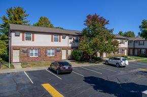 Columbus apartment for rent - an apartment building with cars parked in a parking lot