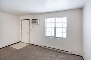Delaware apartment for rent - the living room of an apartment with a window and a door