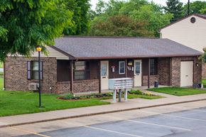 Covington apartment for rent - a small brick building with a sign in front of it