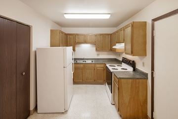 Covington apartment for rent - a kitchen with white appliances and wooden cabinets
