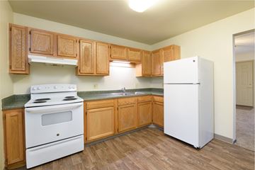 Miamisburg apartment for rent - an empty kitchen with a stove refrigerator and sink